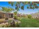 Landscaped backyard with a view of a screened in porch and fenced perimeter at 226 75Th N St, St Petersburg, FL 33710