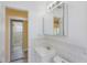 Bright bathroom showcases a vanity with a medicine cabinet, connected to a bedroom space at 226 75Th N St, St Petersburg, FL 33710