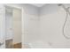Bright bathroom featuring a tiled shower/tub and a view of the adjacent room at 226 75Th N St, St Petersburg, FL 33710