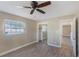 Bedroom with wood-look flooring, neutral walls, a ceiling fan, and a closet at 226 75Th N St, St Petersburg, FL 33710