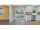 Kitchen with a sink beneath white cabinets and a sliding door leading to the lanai, complemented by an adjacent room at 226 75Th N St, St Petersburg, FL 33710