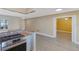 Stainless steel range with a stone-style breakfast bar is set between the kitchen and an adjacent room with a yellow color scheme at 226 75Th N St, St Petersburg, FL 33710