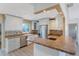 Updated kitchen with stainless steel appliances and a peninsula counter at 226 75Th N St, St Petersburg, FL 33710