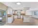 Bright kitchen boasts stainless appliances, modern cabinetry, breakfast bar, and seamlessly connects to living area at 226 75Th N St, St Petersburg, FL 33710