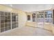 Tiled sunroom with multiple windows and an exterior access point at 226 75Th N St, St Petersburg, FL 33710