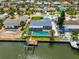 Waterfront home featuring a screened-in pool, dock, and canal access, perfect for boating enthusiasts at 1011 Spindle Palm Way, Apollo Beach, FL 33572