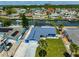 Waterfront home featuring a two-car garage, manicured lawn, and canal access at 1011 Spindle Palm Way, Apollo Beach, FL 33572