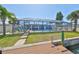 A screened pool and spacious backyard create a relaxing outdoor space at 1011 Spindle Palm Way, Apollo Beach, FL 33572