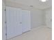 Bedroom with tile flooring and bi-fold closet doors at 1011 Spindle Palm Way, Apollo Beach, FL 33572
