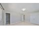 Neutral bedroom showcasing tile floors, recessed lighting and en-suite bathroom and closet at 1011 Spindle Palm Way, Apollo Beach, FL 33572