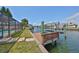 Waterfront property with a private dock offering direct access to the water and easy boat storage at 1011 Spindle Palm Way, Apollo Beach, FL 33572