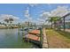 Beautiful waterfront home featuring a boat dock with boat lift, and water access at 1011 Spindle Palm Way, Apollo Beach, FL 33572
