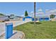 Charming blue single-Gathering home featuring a well-maintained lawn, blue mailbox and a two-car garage at 1011 Spindle Palm Way, Apollo Beach, FL 33572