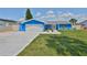 Charming one-story home with a well-manicured lawn, pretty landscaping and an attached garage at 1011 Spindle Palm Way, Apollo Beach, FL 33572