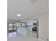 Bright kitchen featuring white cabinetry, stainless steel appliances, and a spacious island overlooking the pool at 1011 Spindle Palm Way, Apollo Beach, FL 33572