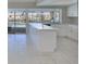 Open kitchen featuring a large island, sleek white cabinets, and views of the pool and waterfront at 1011 Spindle Palm Way, Apollo Beach, FL 33572