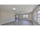 Spacious living room with sleek gray flooring and lots of natural light at 1011 Spindle Palm Way, Apollo Beach, FL 33572