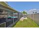 A delightful screened in pool and seating area with lush grass and beautiful water views at 1011 Spindle Palm Way, Apollo Beach, FL 33572