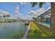 Waterfront property with a private dock, boat lift, pool, and screened enclosure offers outdoor living at 1011 Spindle Palm Way, Apollo Beach, FL 33572
