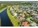 Aerial view showcasing the community with a pond, lush greenery, and well-maintained homes at 10540 Carloway Hills Dr, Wimauma, FL 33598