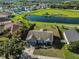 Aerial view showcases home with a private backyard, waterway view, and neighborhood at 10540 Carloway Hills Dr, Wimauma, FL 33598