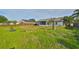 Large backyard featuring a patio, well-maintained lawn, and a privacy fence at 10540 Carloway Hills Dr, Wimauma, FL 33598