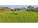 Fenced backyard with green lawn and screened in patio, ideal for relaxing and entertaining at 10540 Carloway Hills Dr, Wimauma, FL 33598