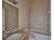 Neutral bathroom featuring tiled shower/tub and vanity with granite countertop at 10540 Carloway Hills Dr, Wimauma, FL 33598