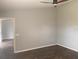 View of a bedroom with light gray walls and dark wood-look floors at 10540 Carloway Hills Dr, Wimauma, FL 33598