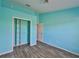Bright blue bedroom with laminate flooring and large closet provides a cozy and inviting space at 10540 Carloway Hills Dr, Wimauma, FL 33598