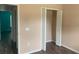 An empty bedroom with wood floors and bi-fold closet doors at 10540 Carloway Hills Dr, Wimauma, FL 33598