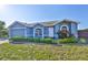 Charming home featuring a well-manicured lawn, and a welcoming front entrance at 10540 Carloway Hills Dr, Wimauma, FL 33598