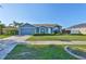 Charming single-story home with a two-car garage and manicured front yard landscaping at 10540 Carloway Hills Dr, Wimauma, FL 33598