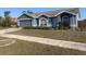 Charming single-story home with a well-maintained lawn, a two-car garage and manicured landscaping at 10540 Carloway Hills Dr, Wimauma, FL 33598