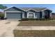 Charming single-story home with a well-maintained lawn, a two-car garage and manicured landscaping at 10540 Carloway Hills Dr, Wimauma, FL 33598