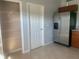 A spacious kitchen featuring tile floors, stainless steel appliances, and a pantry at 10540 Carloway Hills Dr, Wimauma, FL 33598