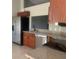 Kitchen area with stainless steel appliances and wood cabinetry at 10540 Carloway Hills Dr, Wimauma, FL 33598