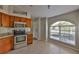 Kitchen features stainless steel appliances, tile floors, wood cabinets, and a breakfast nook at 10540 Carloway Hills Dr, Wimauma, FL 33598