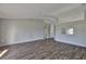 Spacious living room with stylish wood flooring and plenty of natural light at 10540 Carloway Hills Dr, Wimauma, FL 33598