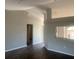 Bright open-concept living room featuring high ceilings and sleek flooring at 10540 Carloway Hills Dr, Wimauma, FL 33598