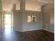 Open-concept living room featuring hardwood floors and neutral paint scheme at 10540 Carloway Hills Dr, Wimauma, FL 33598