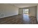 Bright and airy living room featuring modern floors and access to outdoor screened room at 10540 Carloway Hills Dr, Wimauma, FL 33598