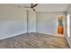 Bright main bedroom with wood floors and an attached bathroom at 10540 Carloway Hills Dr, Wimauma, FL 33598