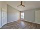 Main bedroom featuring vaulted ceiling, wood floors, and large windows at 10540 Carloway Hills Dr, Wimauma, FL 33598