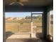 A screened-in patio overlooking a large backyard and pond at 10540 Carloway Hills Dr, Wimauma, FL 33598