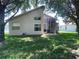 Rear exterior of home showing screened-in porch and manicured lawn at 11185 Heathrow Ave, Spring Hill, FL 34609