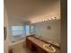 Well-lit bathroom with dual sinks, vanity, and a large soaking tub at 11185 Heathrow Ave, Spring Hill, FL 34609
