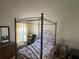 Bedroom with four poster wrought iron bed frame and wooden dresser at 11185 Heathrow Ave, Spring Hill, FL 34609