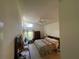 Bright bedroom featuring vaulted ceiling, comfortable furnishings, and a ceiling fan at 11185 Heathrow Ave, Spring Hill, FL 34609
