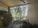 Covered lanai with ceiling fan overlooking fenced in yard with mature trees at 11185 Heathrow Ave, Spring Hill, FL 34609